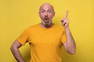 guy raise finger up feels amazed surprised by suddenly invented a great idea