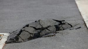 Asphalt road damaged. cracked road after earthquake. Poor asphalt surface.