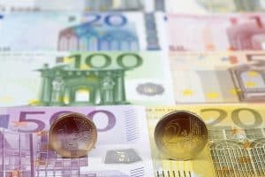 Euro coins on the background of banknotes